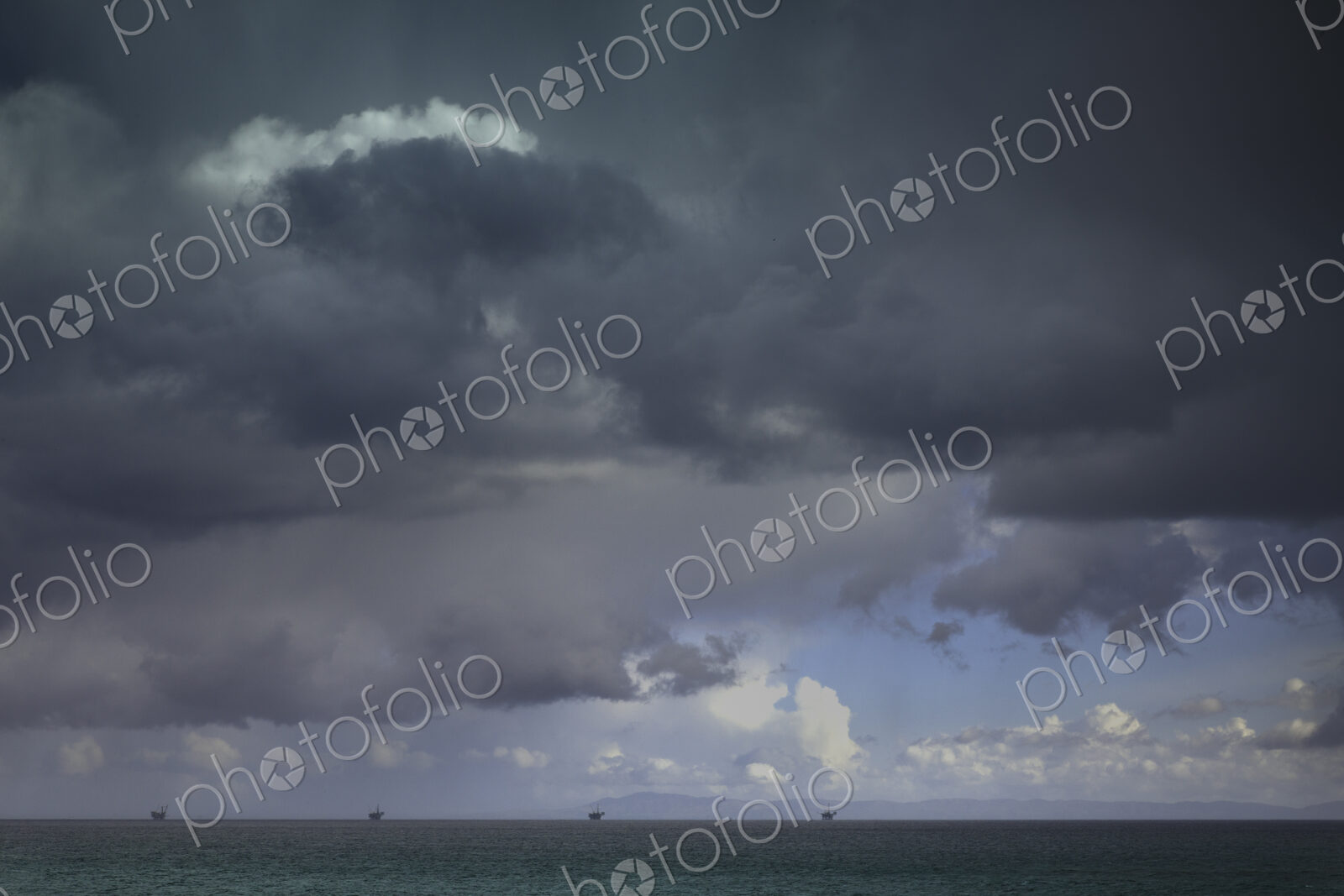 Cloudy dark sky above rural landscape.