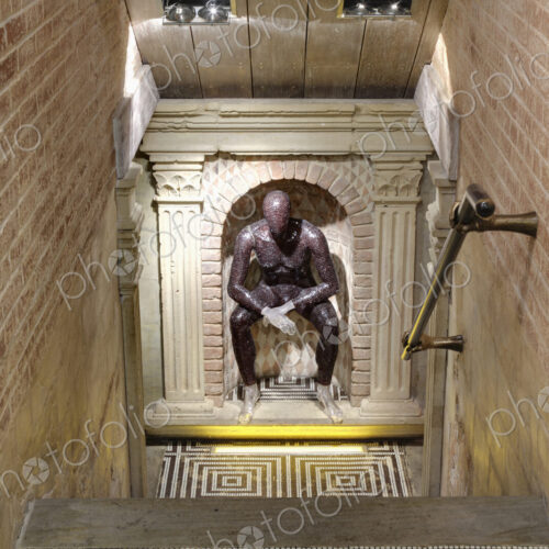 Club interior, a sculpture of a seated figure at the bottom of steps