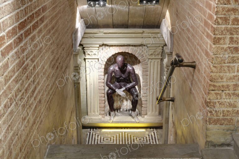 Club interior, a sculpture of a seated figure at the bottom of steps