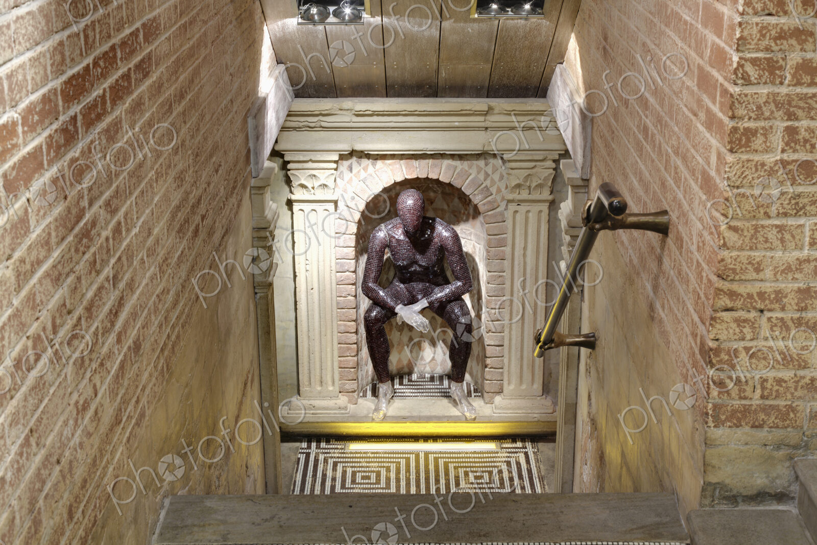 Club interior, a sculpture of a seated figure at the bottom of steps
