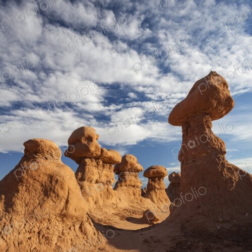 Cluster of unique hoodoo rock formations in Goblin Valley State Park, Utah, rising…