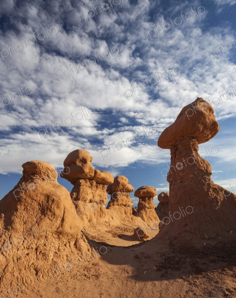 Cluster of unique hoodoo rock formations in Goblin Valley State Park, Utah, rising…