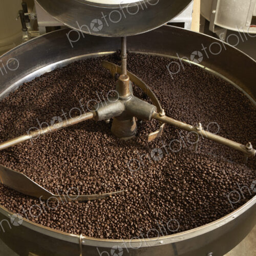 Coffee beans roasting in industrial kettle