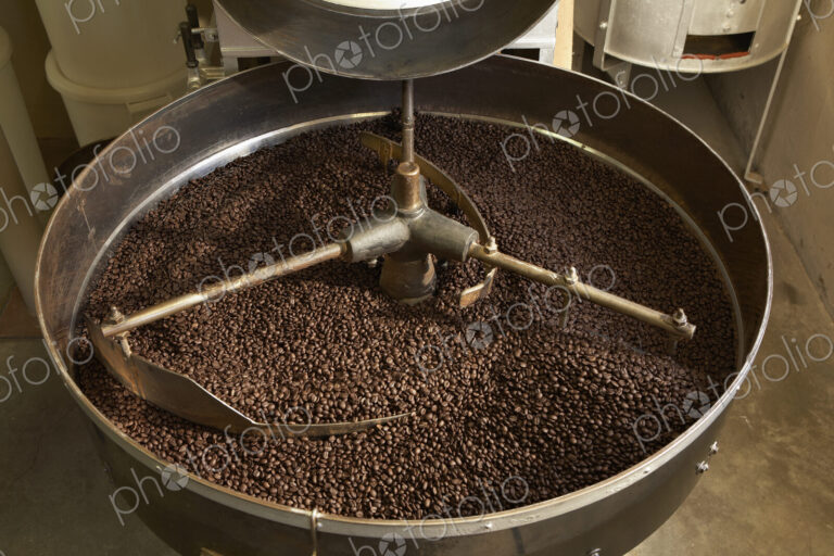 Coffee beans roasting in industrial kettle