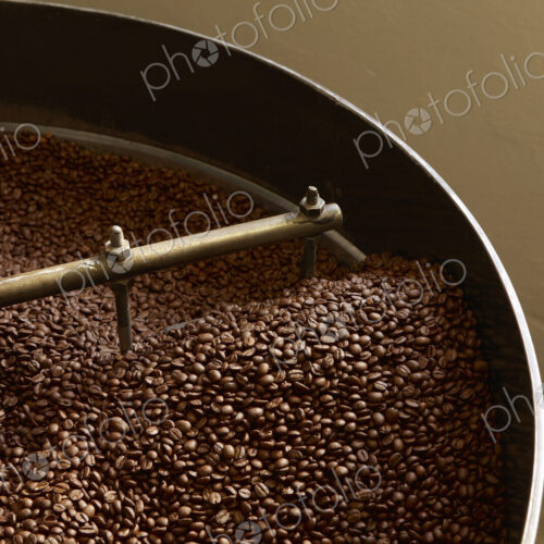 Coffee beans roasting in industrial kettle