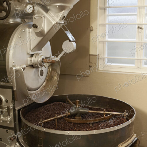 Coffee beans roasting in industrial kettle