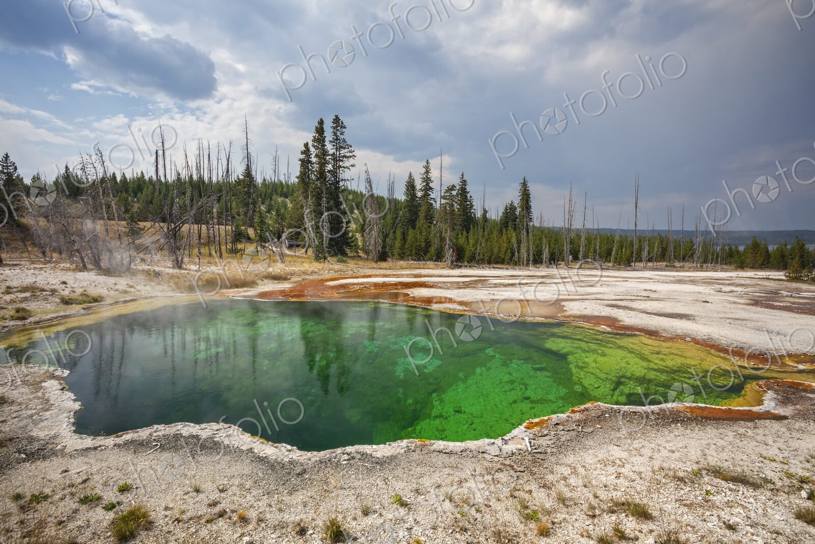 Colorful Abyss Pool in Yellowstone’s West Thumb Geyser Basin with steaming hot spring…