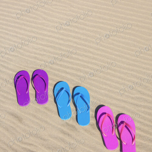 Colorful flip flops on sand Colorful flip flops on sand