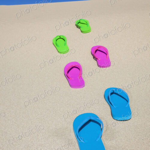 Colorful flip flops on sand Colorful flip flops on sand