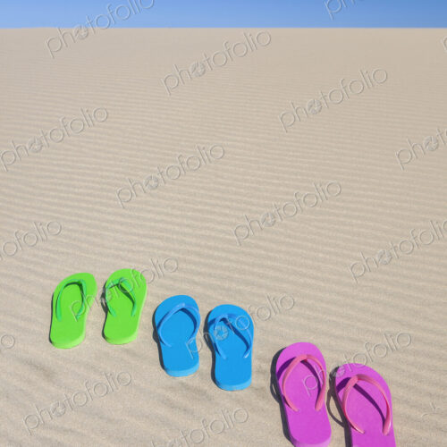 Colorful flip flops on sand dune Colorful flip flops on sand dune