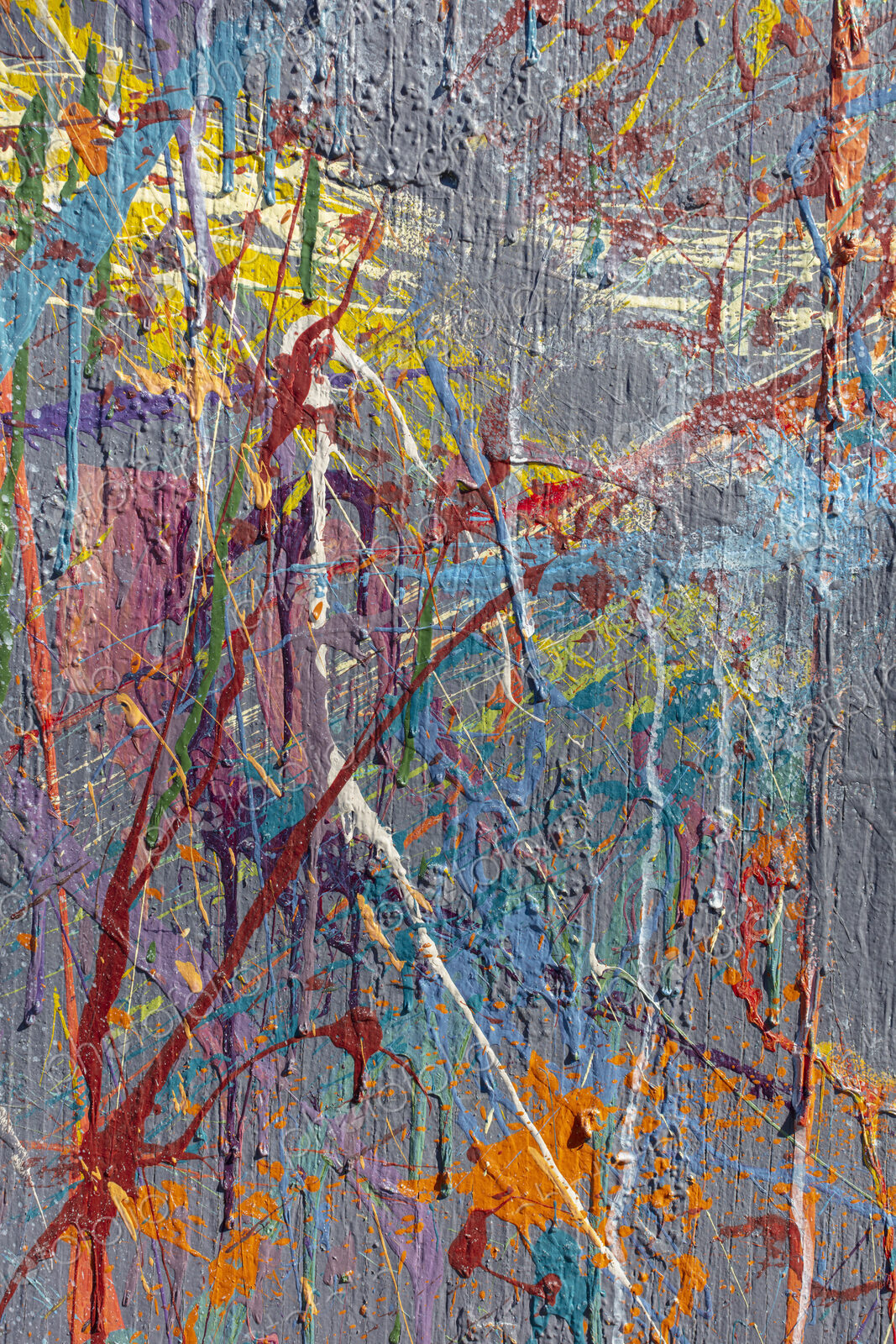 Colorful graffiti paint splattered and dripping on urban wall, close up