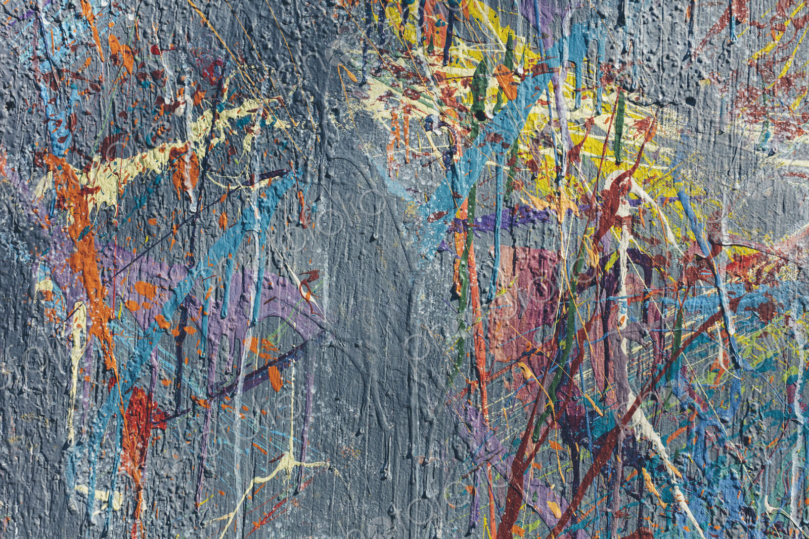 Colorful graffiti paint splattered and dripping on urban wall, close up