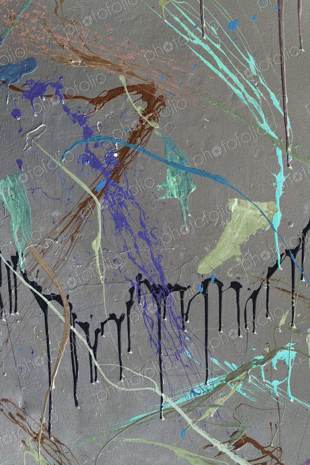 Colorful graffiti paint splattered and dripping on urban wall, close up