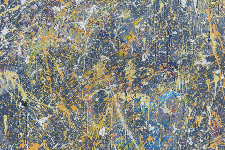 Colorful graffiti paint splattered and dripping on urban wall, close up