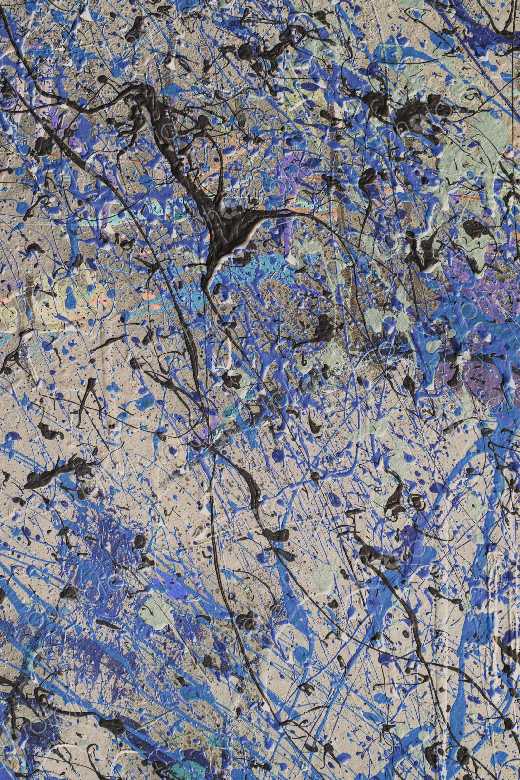 Colorful graffiti paint splattered and dripping on urban wall, close up
