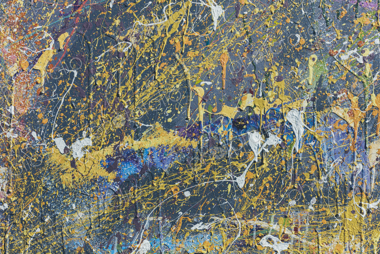 Colorful graffiti paint splattered and dripping on urban wall, close up