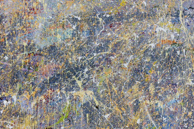 Colorful graffiti paint splattered and dripping on urban wall, close up