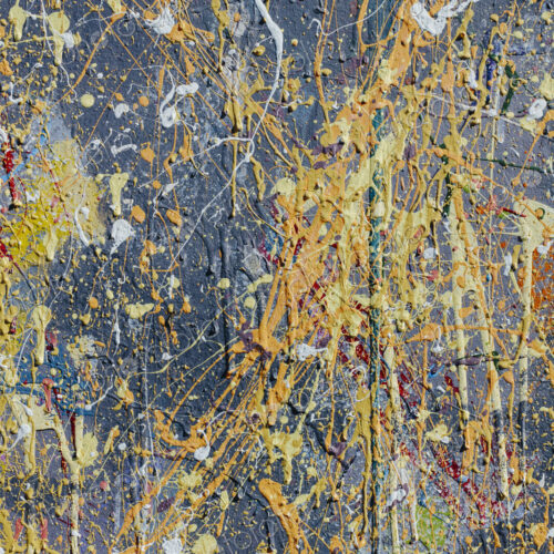 Colorful graffiti paint splattered and dripping on urban wall, close up