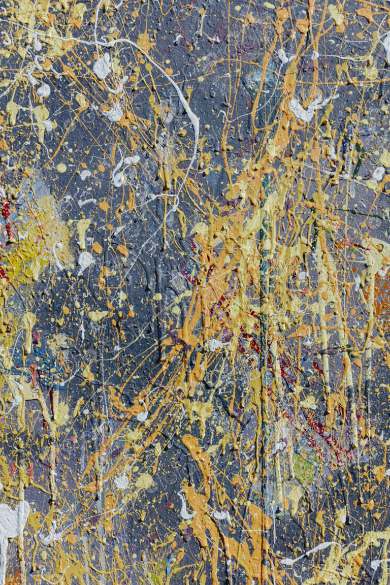 Colorful graffiti paint splattered and dripping on urban wall, close up
