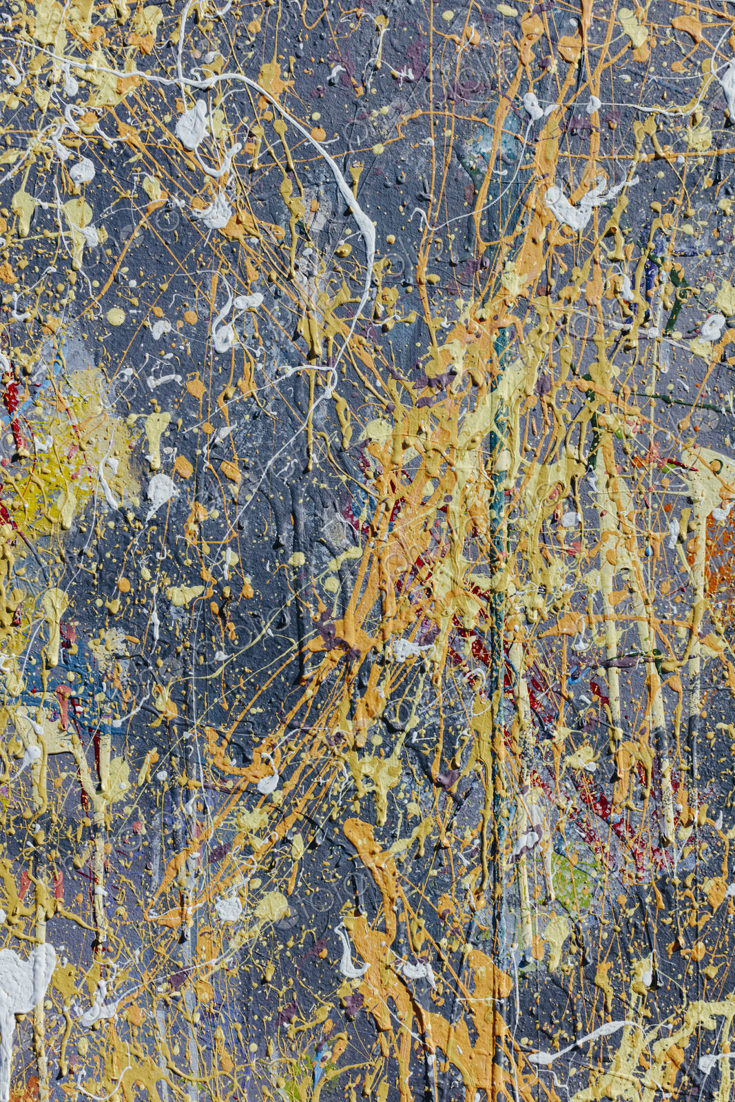 Colorful graffiti paint splattered and dripping on urban wall, close up