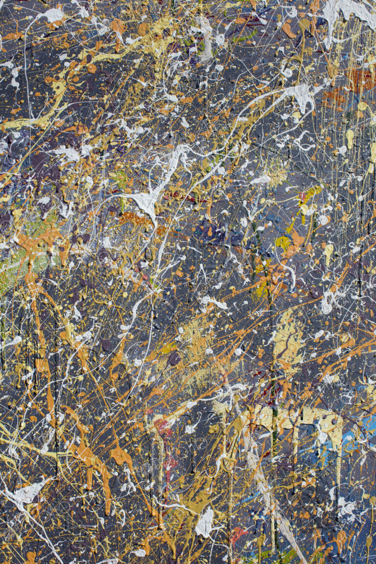 Colorful graffiti paint splattered and dripping on urban wall, close up