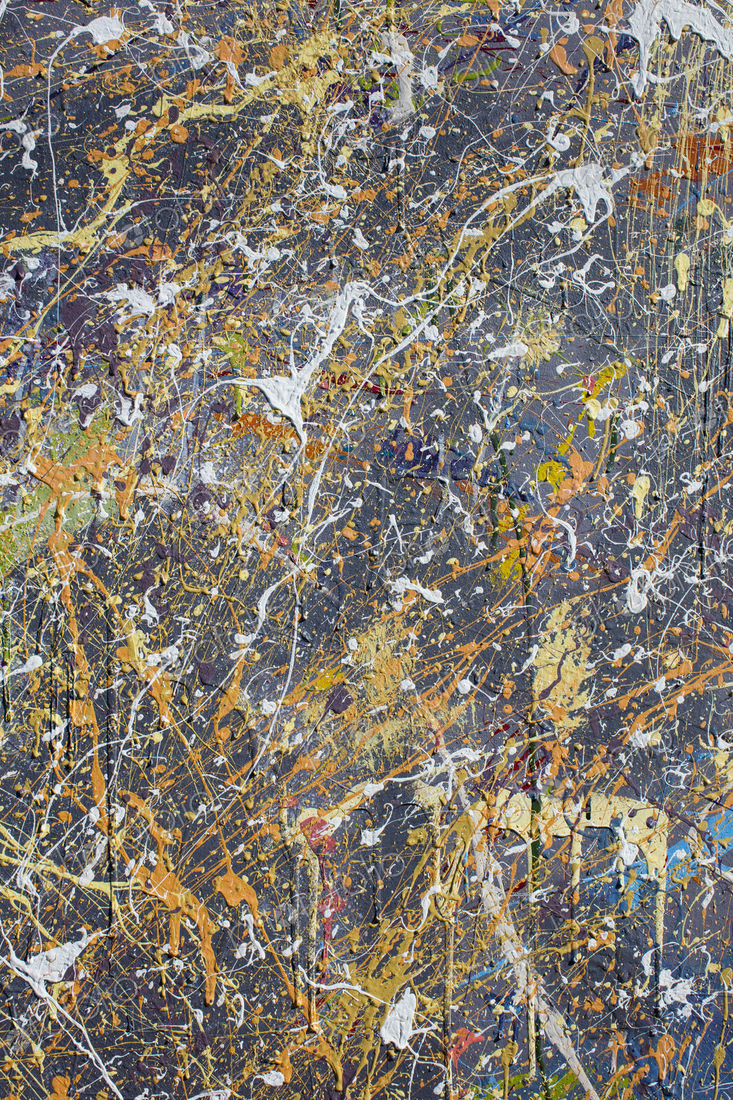Colorful graffiti paint splattered and dripping on urban wall, close up