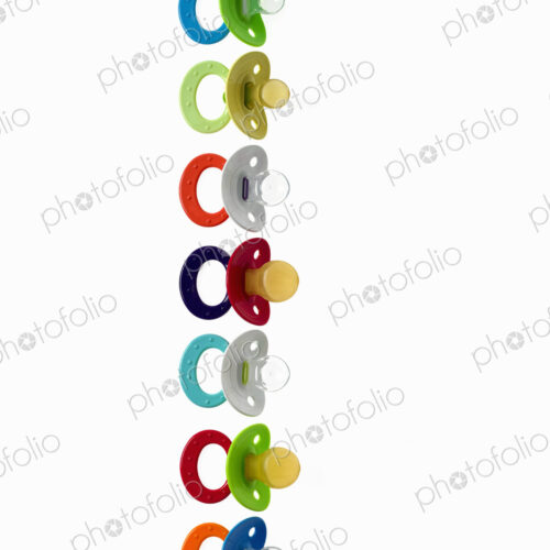 Coloured plastic baby pacifiers, dummies or soothers. Coloured plastic baby pacifiers, dummies or soothers.