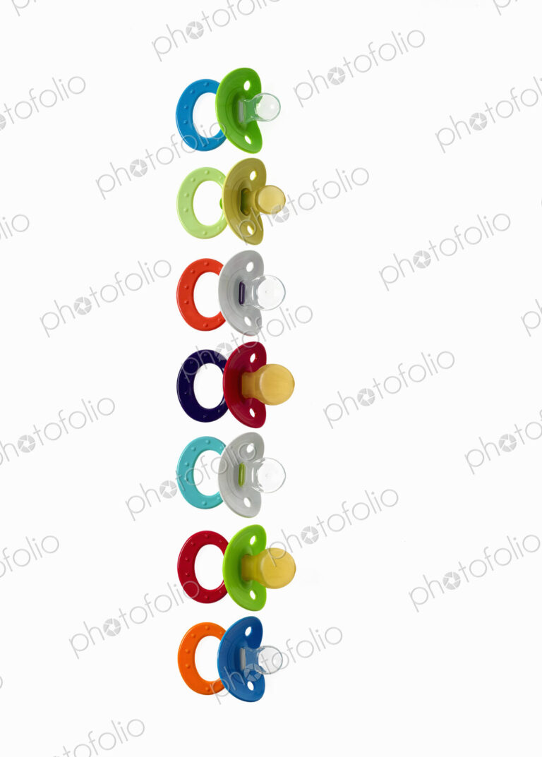Coloured plastic baby pacifiers, dummies or soothers.