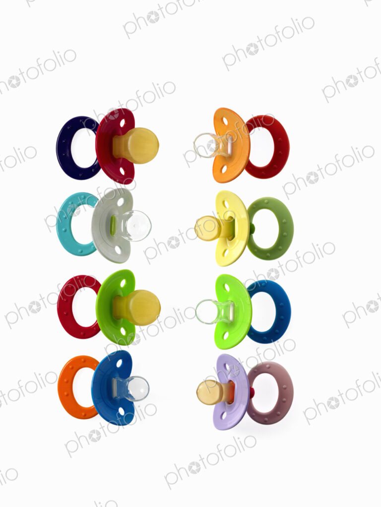Coloured plastic baby pacifiers, dummies or soothers.