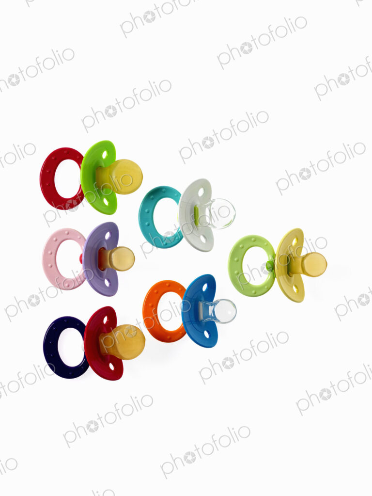 Coloured plastic baby pacifiers, dummies or soothers.