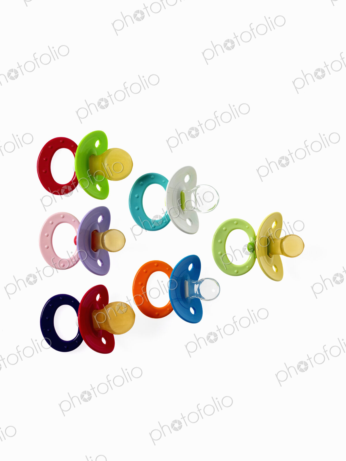 Coloured plastic baby pacifiers, dummies or soothers.