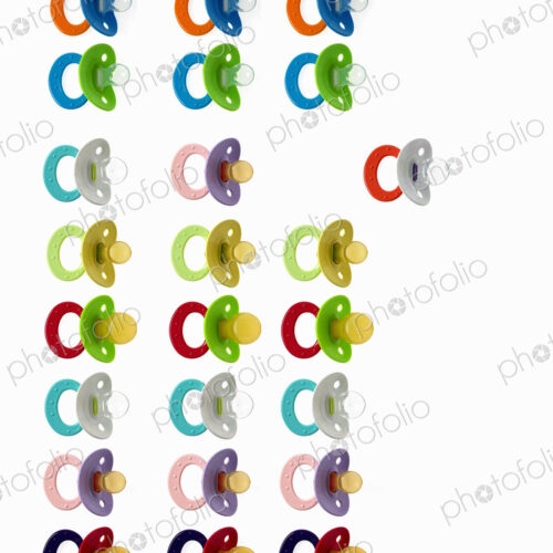 Coloured plastic baby pacifiers, dummies or soothers.
