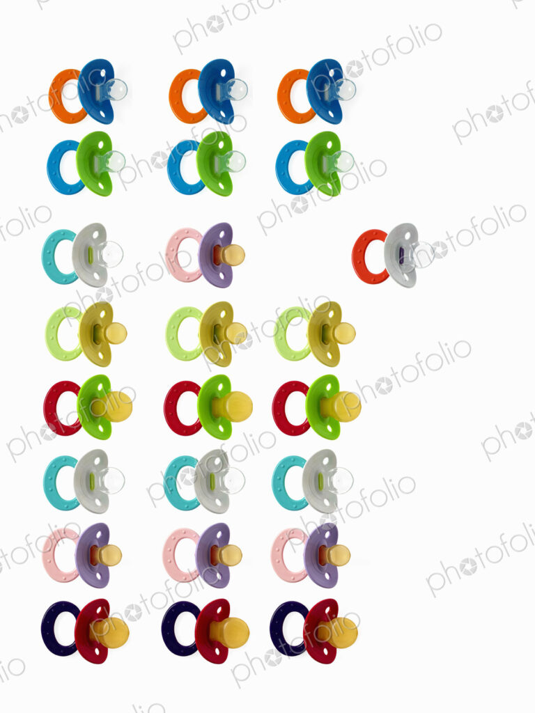 Coloured plastic baby pacifiers, dummies or soothers.