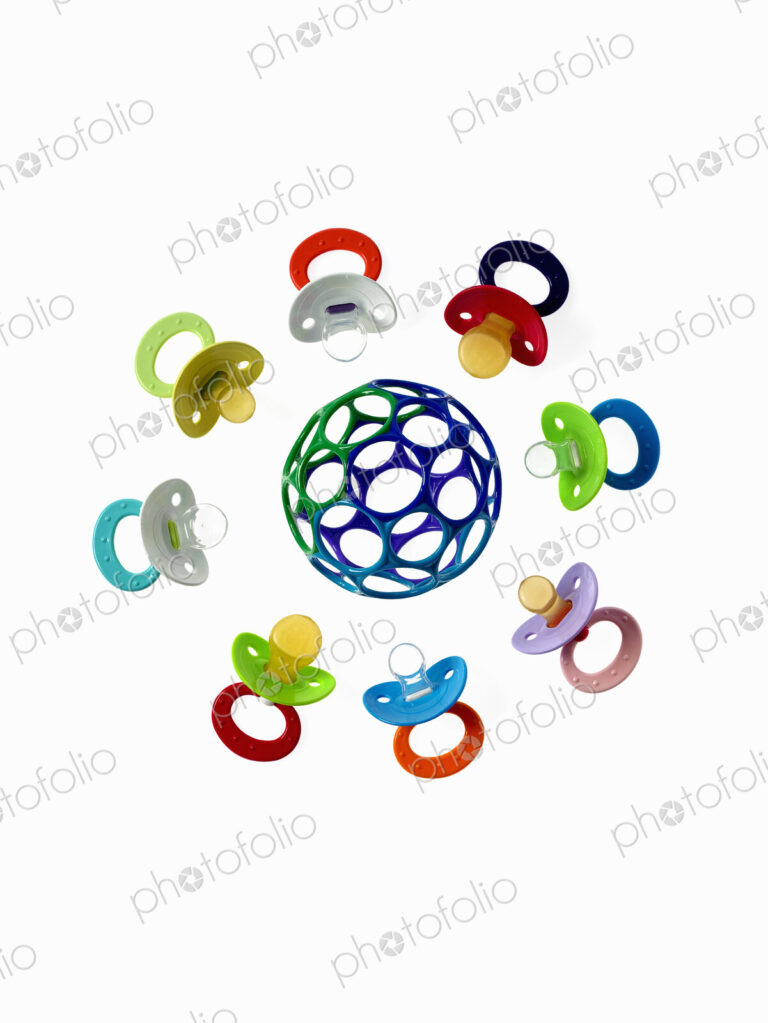 Coloured plastic baby pacifiers, dummies or soothers.