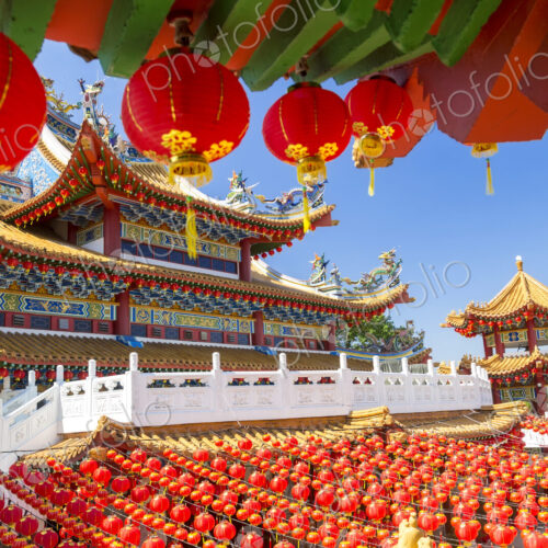 Colourful Chinese temple decorated with an abundance of traditional red paper lanterns. Colourful Chinese temple decorated with an abundance of traditional red paper lanterns.