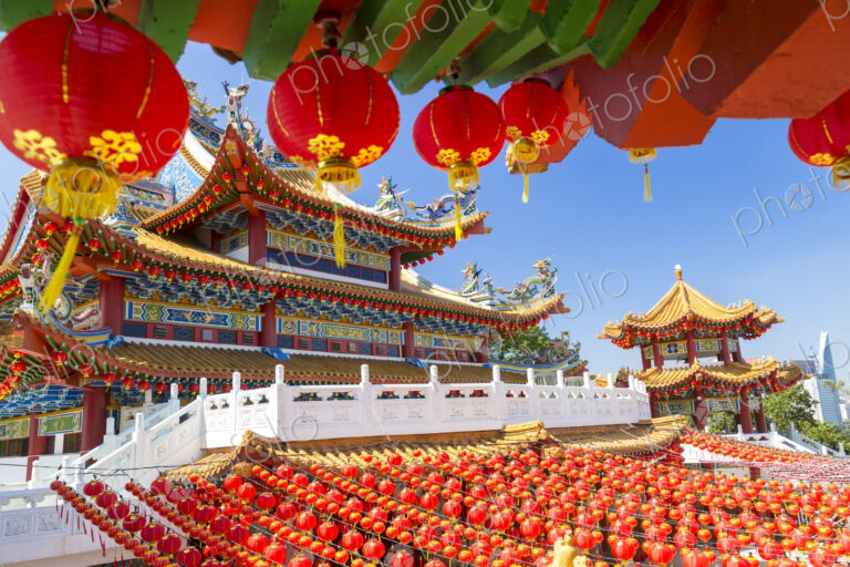 Colourful Chinese temple decorated with an abundance of traditional red paper lanterns.