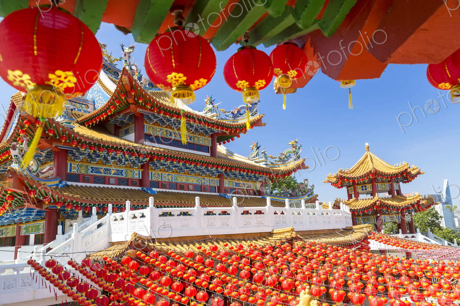 Colourful Chinese temple decorated with an abundance of traditional red paper lanterns.
