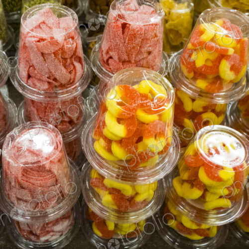 Colourful candy and sweets packed into plastic containers, for sale at Halloween.