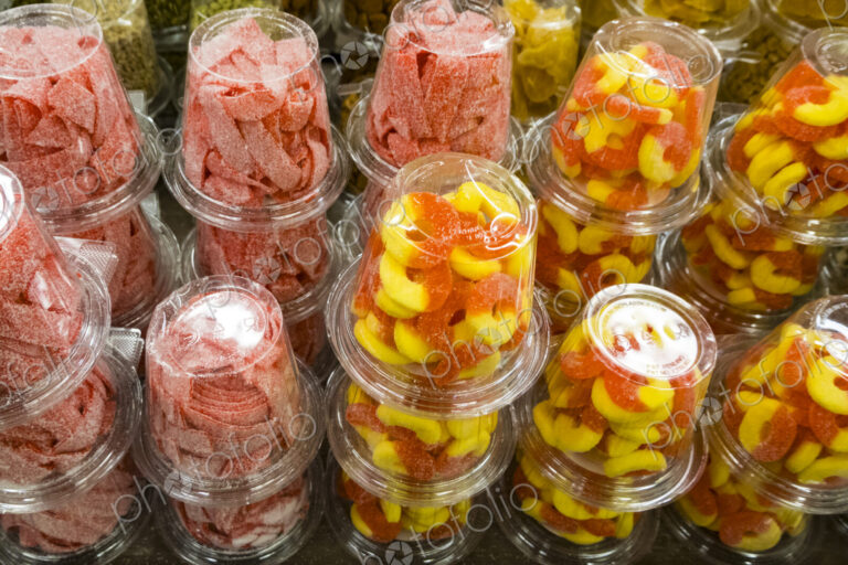 Colourful candy and sweets packed into plastic containers, for sale at Halloween.