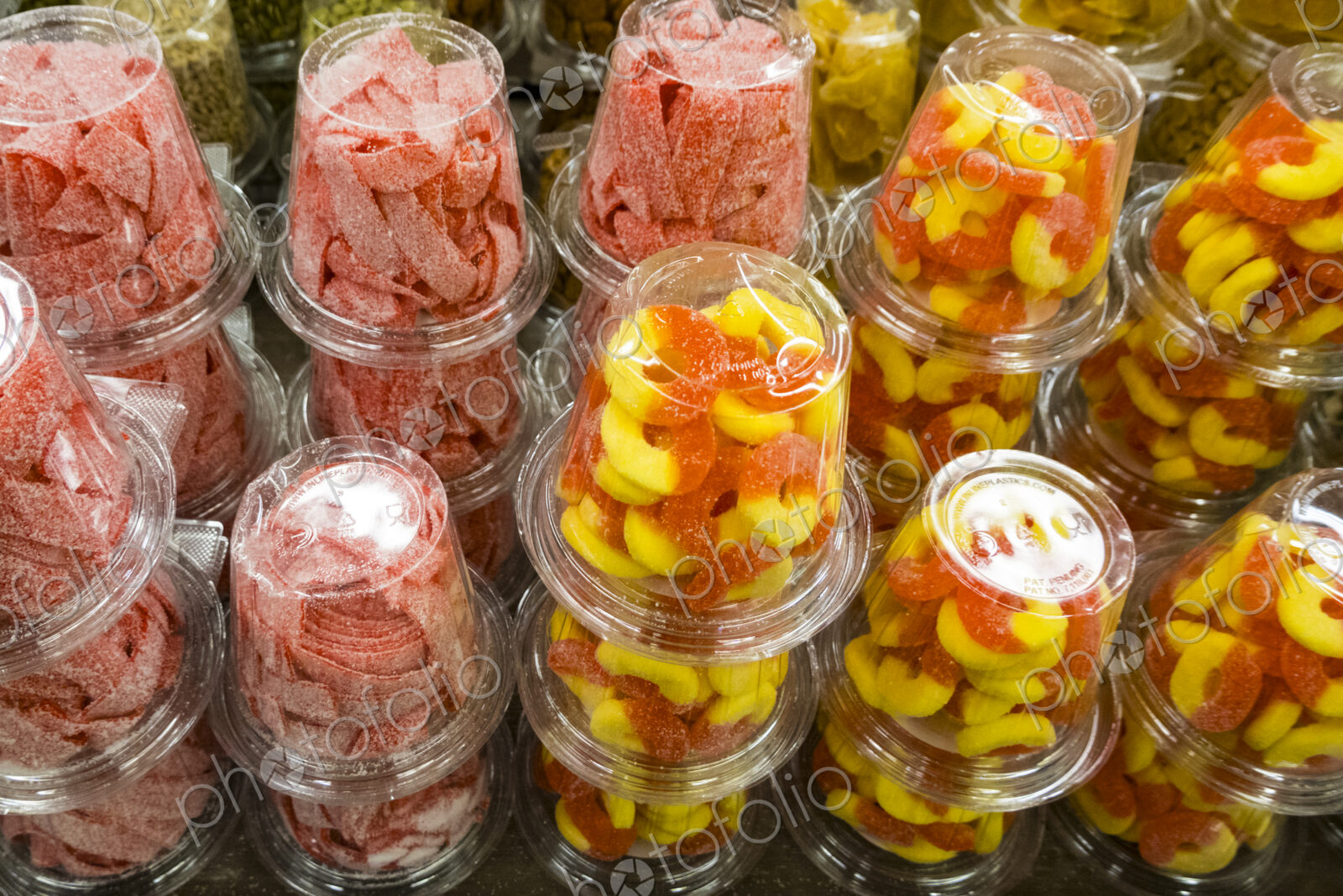 Colourful candy and sweets packed into plastic containers, for sale at Halloween.