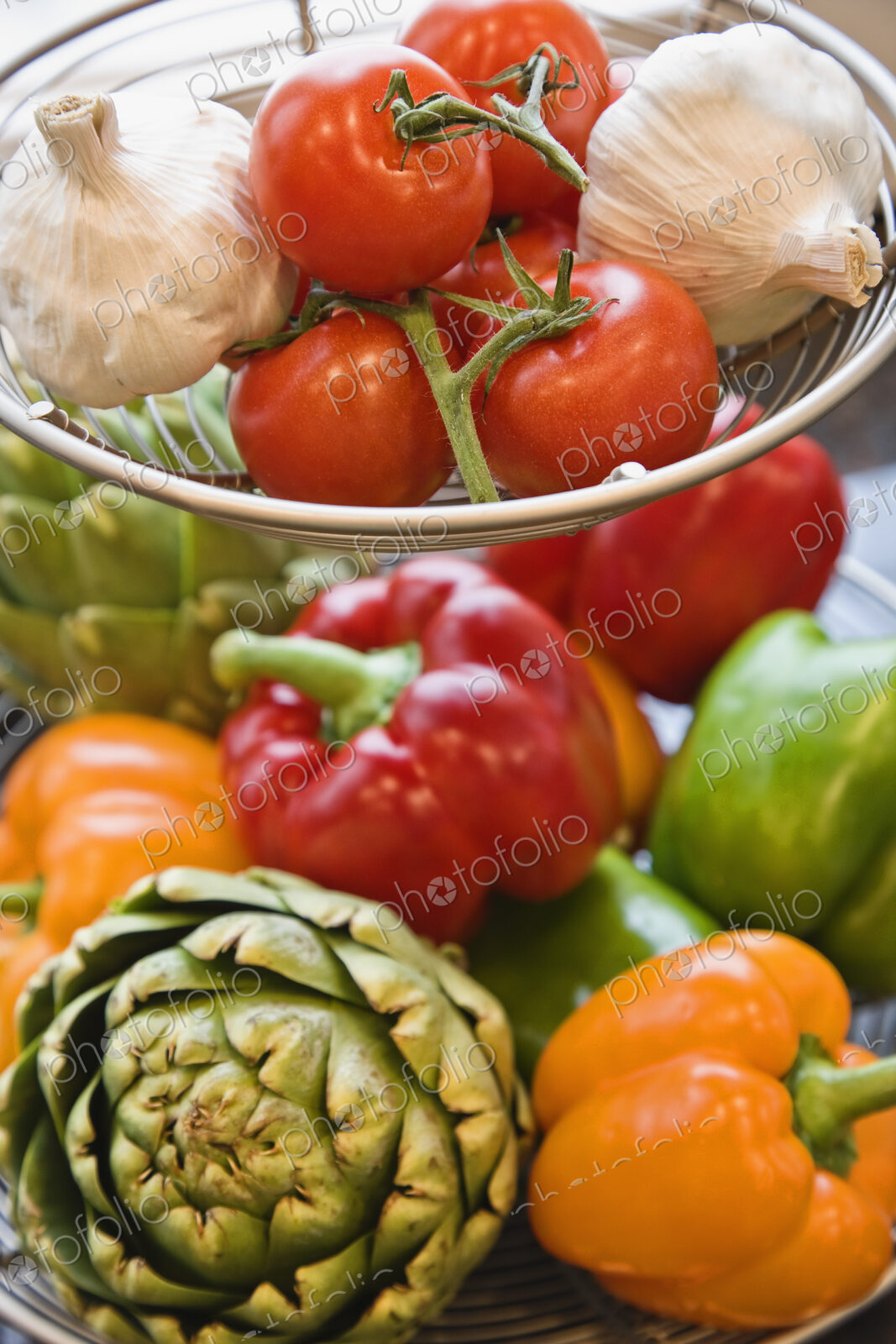 Colourful fresh vegetables on a counter top in a kitchen.