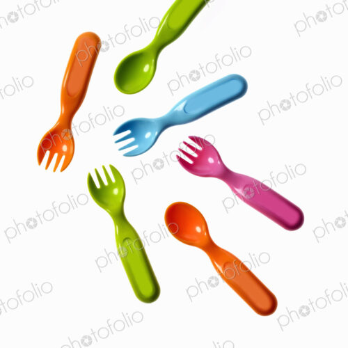 Colourful plastic spoons and forks, for use by infants and babies. Colourful plastic spoons and forks, for use by infants and babies.
