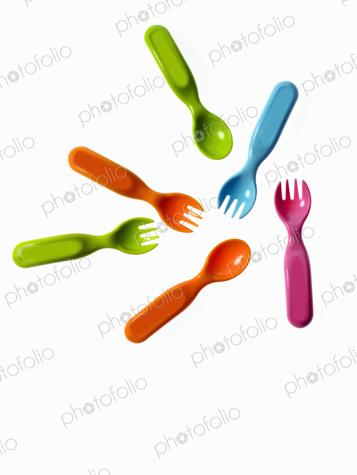 Colourful plastic spoons and forks, for use by infants and babies.