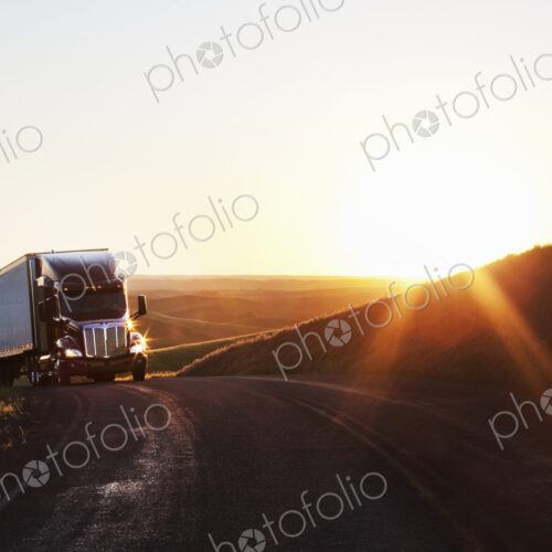Commercial truck cresting a hill in the farm country of eastern Washington, USA Commercial truck cresting a hill in the farm country of eastern Washington, USA