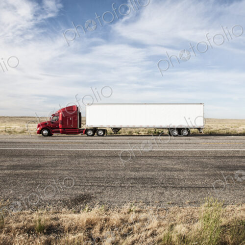 Commercial truck driving through the high desert country of eastern Washington, USA Commercial truck driving through the high desert country of eastern Washington, USA