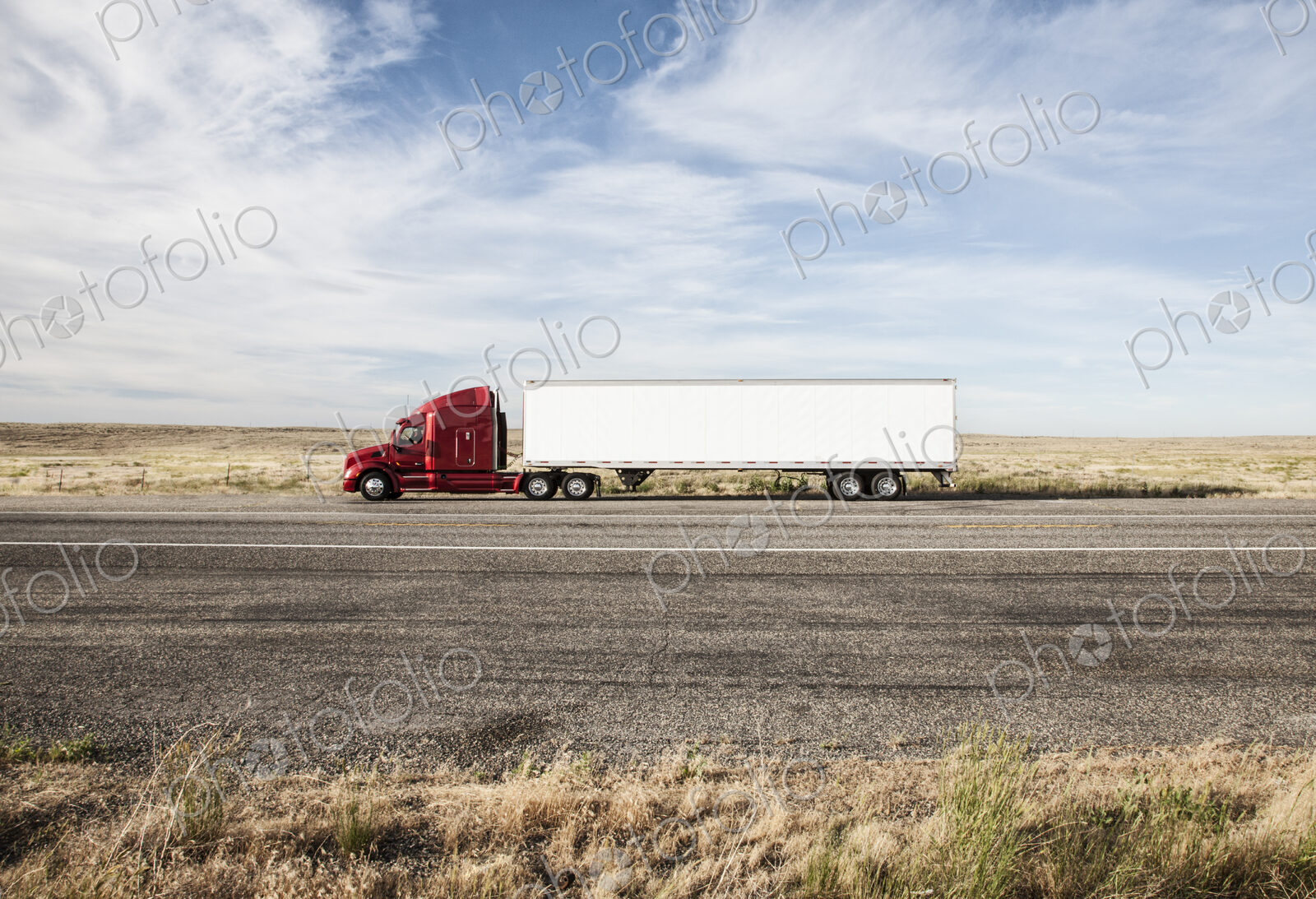 Commercial truck driving through the high desert country of eastern Washington, USA