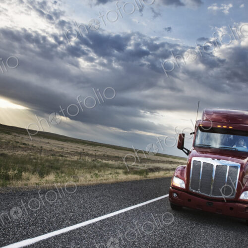 Commercial truck driving through the high desert country of eastern Washington, USA Commercial truck driving through the high desert country of eastern Washington, USA