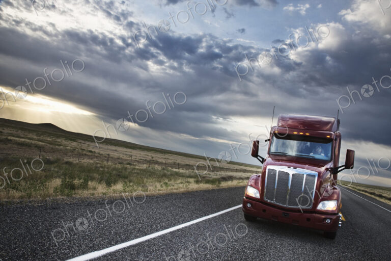 Commercial truck driving through the high desert country of eastern Washington, USA
