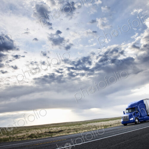 Commercial truck driving through the high desert country of eastern Washington, USA