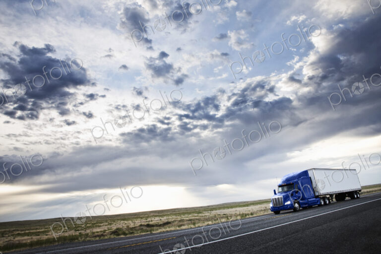 Commercial truck driving through the high desert country of eastern Washington, USA